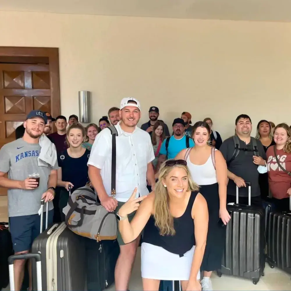 a group of people standing around with luggage.